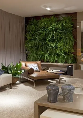Muro verde em sala de estar com cadeira de couro e luminária de piso cinza (foto: Revista Viva Decora)