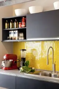 O revestimento amarelo ilumina a decoração da cozinha