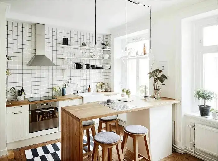 Estilos de cozinhas: modelo de cozinha escandinava com bancada de madeira. Fonte: Bartz Móveis Planejados