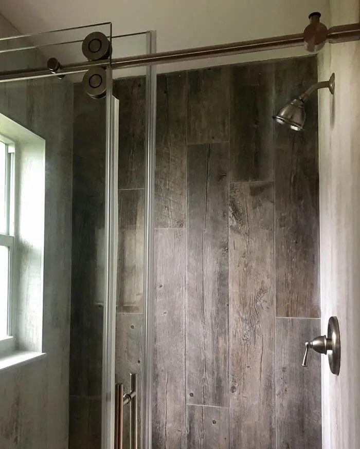 Banheiro externo simples o box de vidro com portas de correr otimizam o espaço do projeto. Fonte: Florida Palm Construction