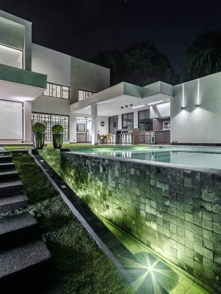 Iluminação de piscina destaca revestimento verde (foto: Gustavo Martins Arquitetura)
